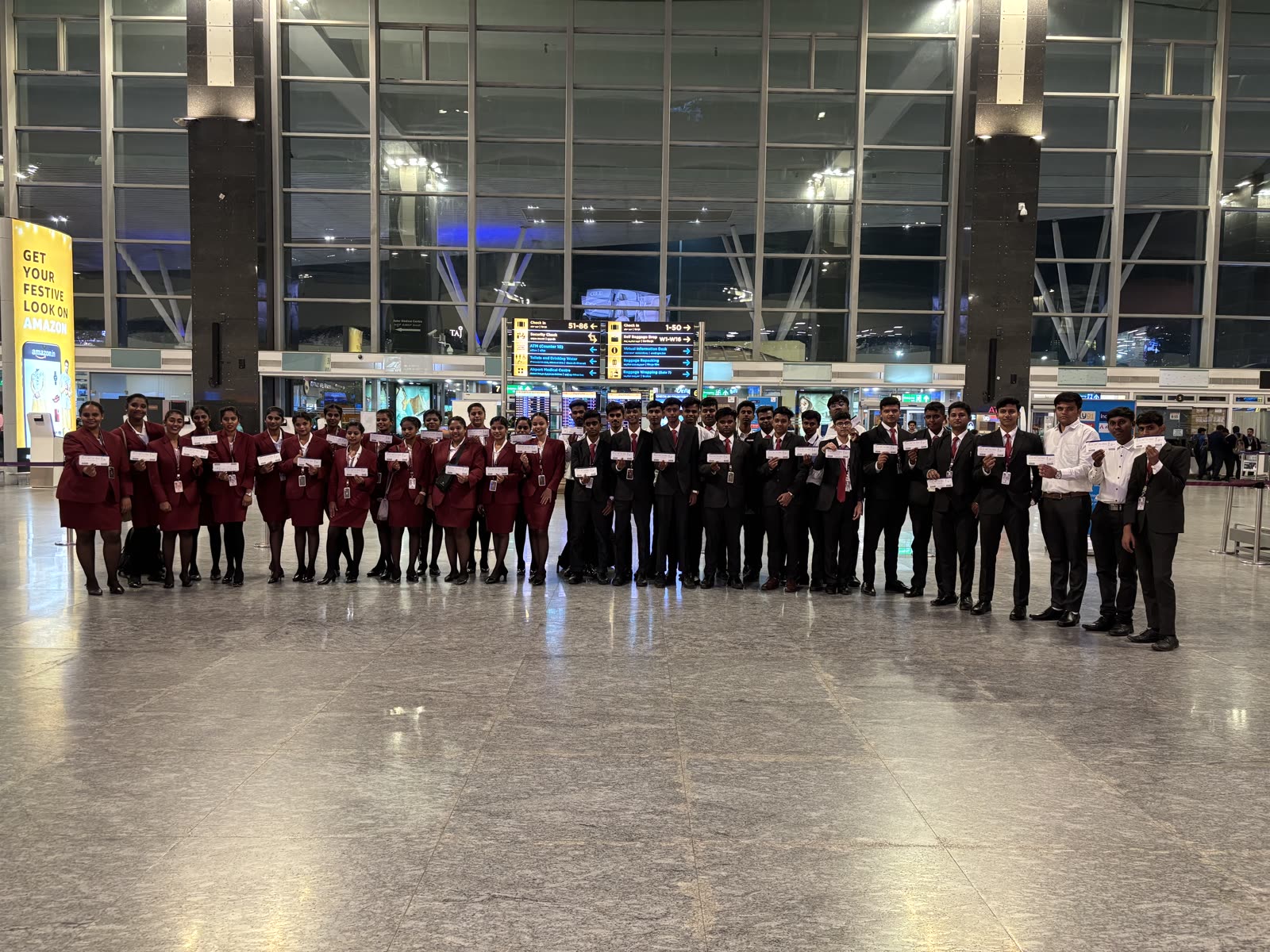 Students holding up their boarding passes inside the terminal before a night training flight