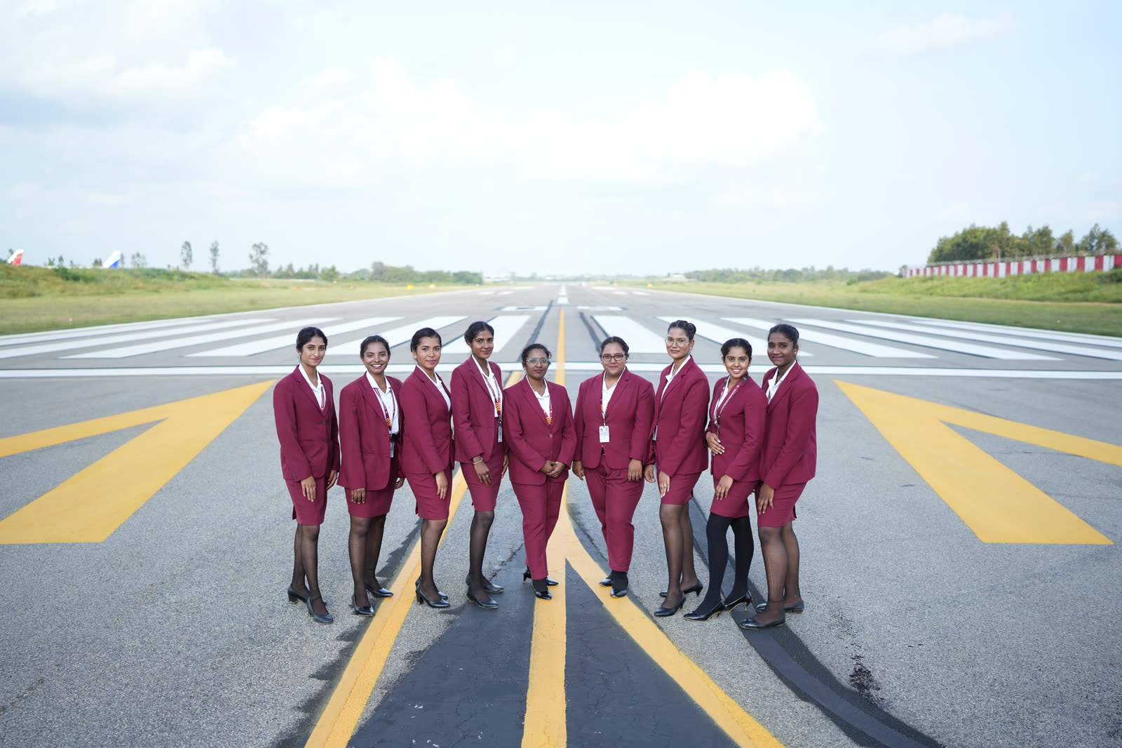 Nine cabin crew trainees standing on the runway centreline