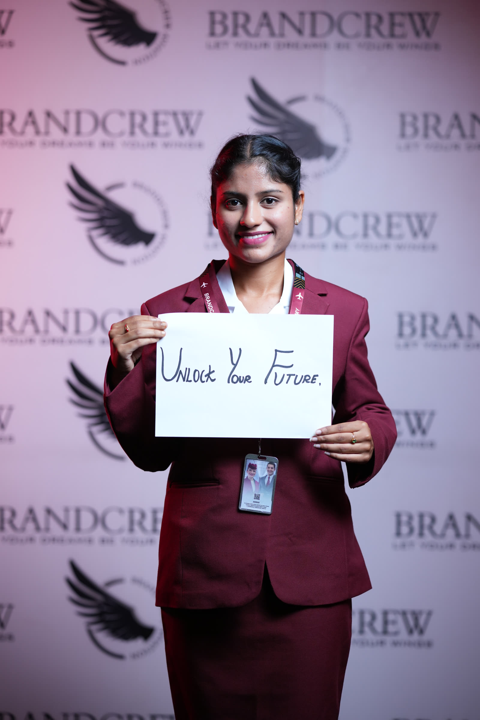 A student in uniform holding a handwritten sign reading Unlock Your Future