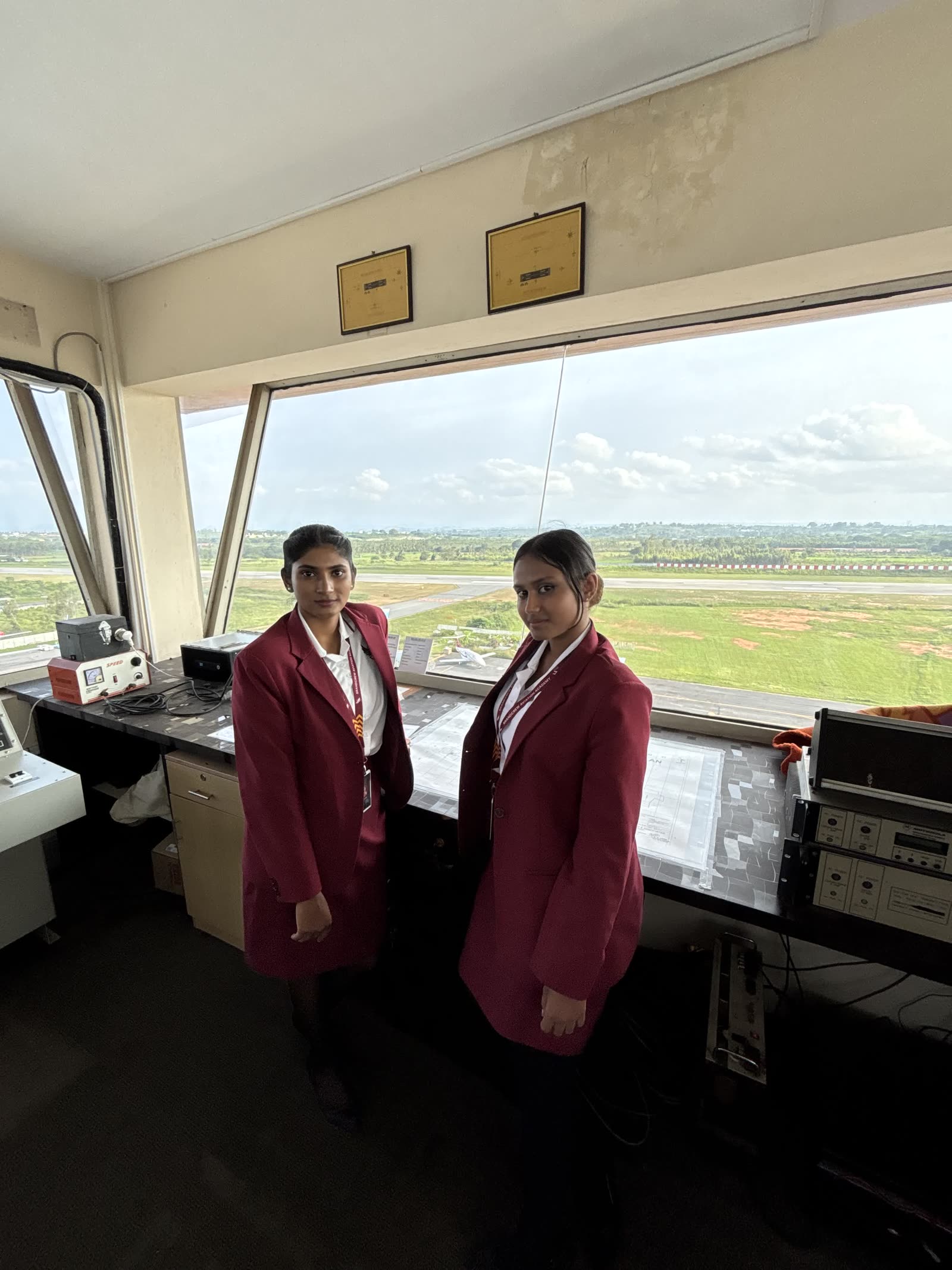 Two students beside the consoles of an air traffic control tower