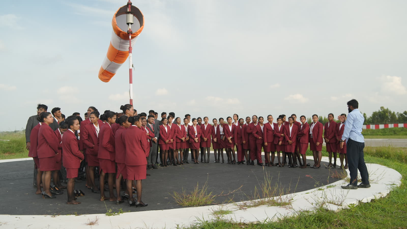 The instructor explaining wind direction beside the windsock