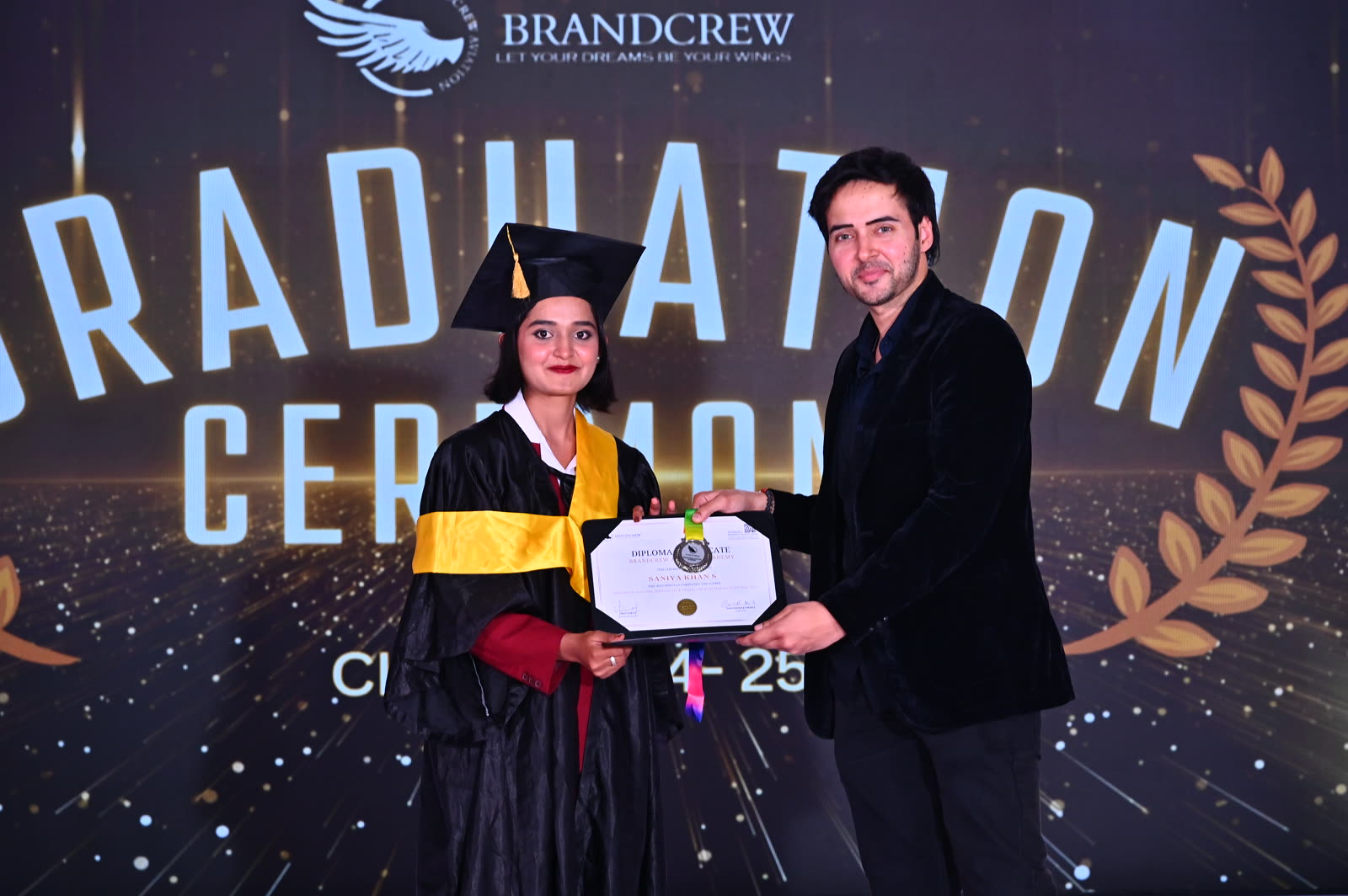 A Brandcrew student receiving their certificate at the graduation ceremony