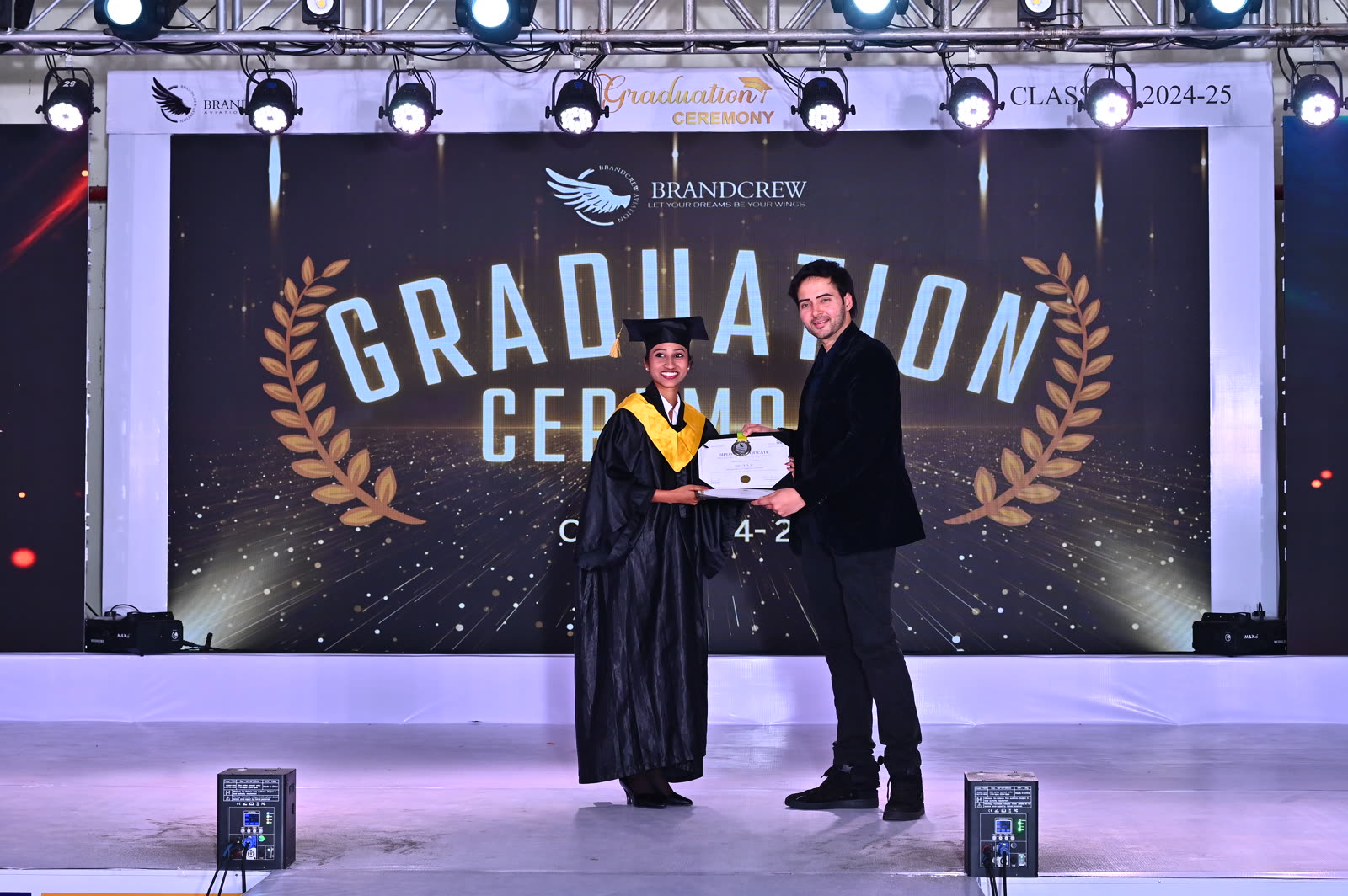 A Brandcrew student receiving their certificate at the graduation ceremony