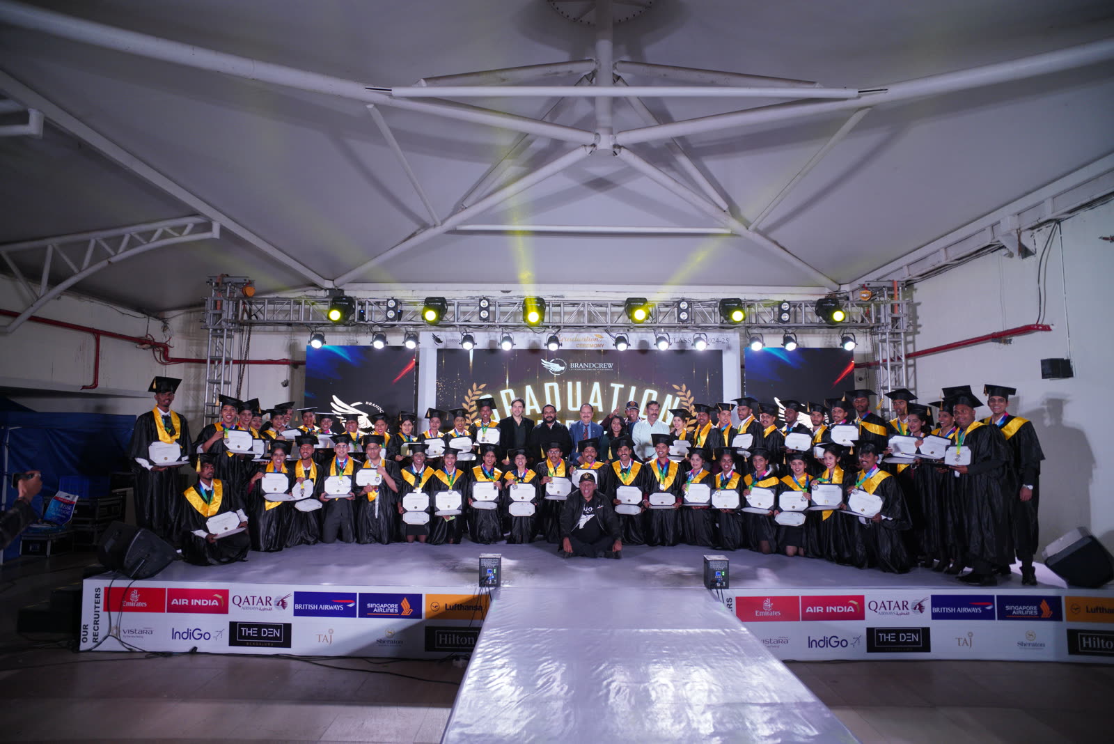 A Brandcrew student receiving their certificate at the graduation ceremony